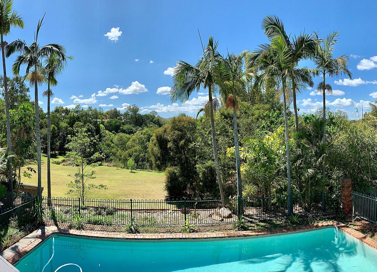 family backyard pool surrounded by a timber deck